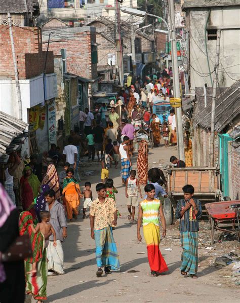 The hustle-bustle of a typical street in the slums, Dhaka, Bangladesh, July 2007. 94 percent of ...