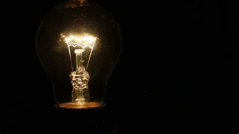 A Light Bulb Illuminates in a Dark Room, Stock Footage | VideoHive