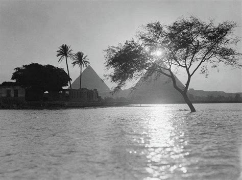 A view of the Pyramids of Giza along the Nile River at sunset. Photograph, 1934. | Pyramids of ...