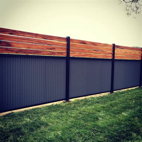 Custom privacy fence. Built out of metal post, tiger wood, and ...