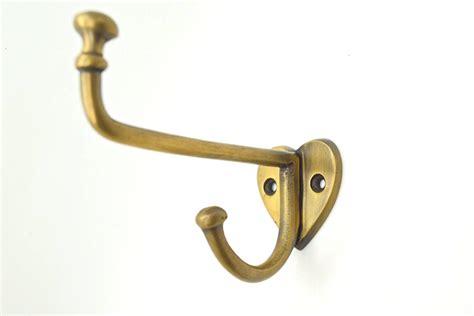 Brass wall and door hooks. Long heart based brass hook. Great for hat and coat hooks. Solid ...