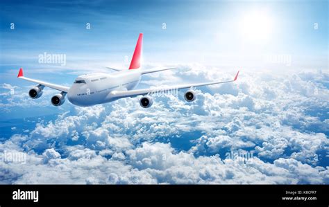 Airplane flying above clouds Stock Photo - Alamy