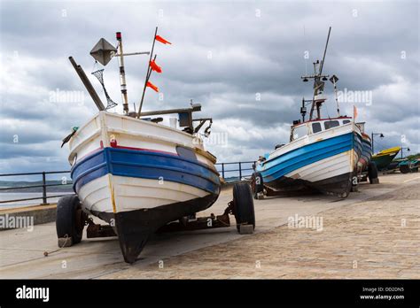 Heavy sky over fishing boats at Filey Yorkshire England UK Stock Photo - Alamy