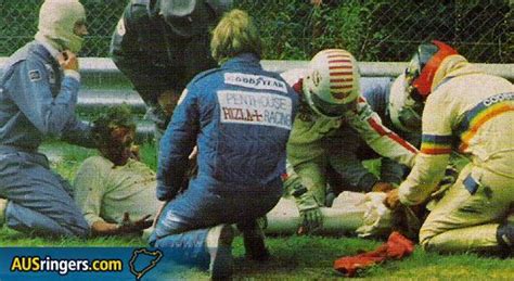 The injured Niki Lauda after the other drivers have pulled him out of his burning Ferrari ...