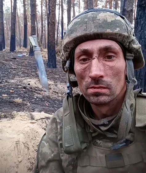 1000 Yard Stare: a very battle weary Ukrainian Army soldier, takes a photo with a Russian Grad ...