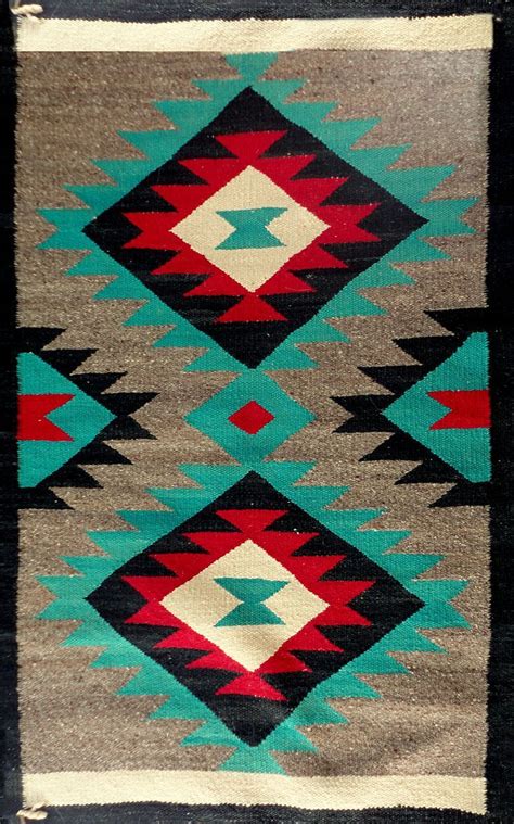 an old navajo rug is shown with different colors and designs on the side, including red, green ...