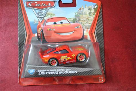 Disney Pixar CARS 2 - HUDSON HORNET PISTON CUP LIGHTNING MCQUEEN- new SEALED pkg