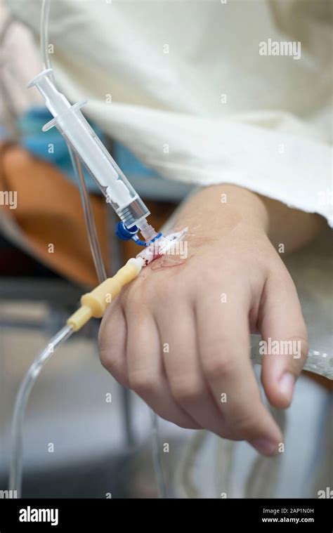 intravenous injection to the child. Hand of a child with a needle. Intravenous infusion system ...