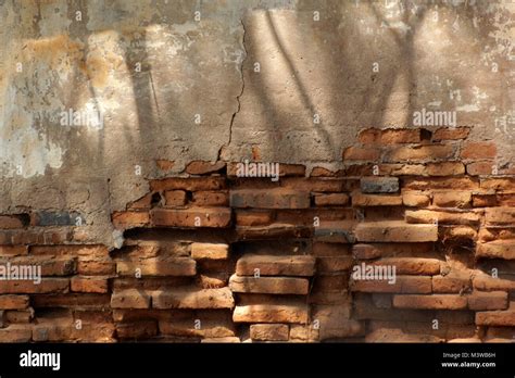 old cracked brick wall as background or texture Stock Photo - Alamy