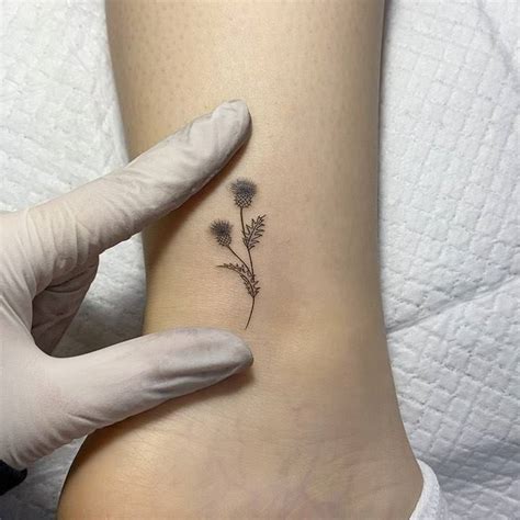 Thistle flower tattoo on the ankle