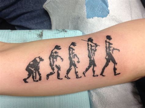 a person with a tattoo on their arm that has the word'evolution'printed ...