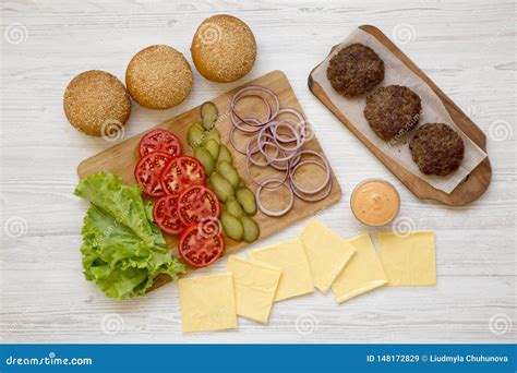 Cheeseburger Ingredients on a White Wooden Surface, Top View. Close-up ...