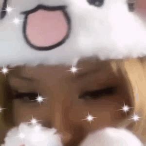 a girl wearing a snowman hat and blowing her nose