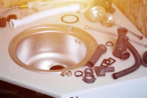 Tools and water tap ready for installation sink on countertop 17018341 Stock Photo at Vecteezy