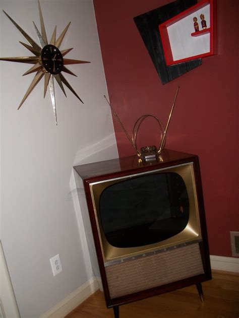 Vintage television with rabbit ear antennae - love the kitchy wall decoration too. Before the ...