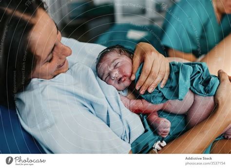 Happy mother hugging newborn baby - a Royalty Free Stock Photo from Photocase