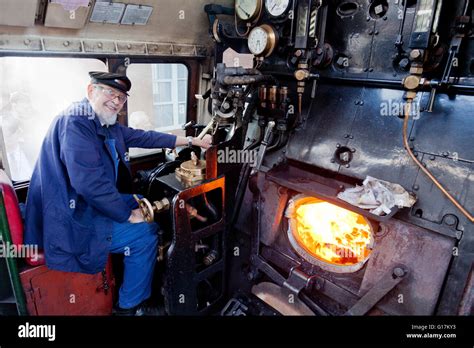 Driver Colin Henderson on the footplate of an Ex-BR 9F freight locomotive 92214 on the West ...