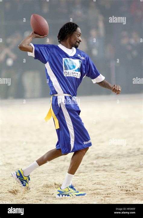 Snoop Dogg throws a football at Directv's Sixth Annual Celebrity Beach Bowl in Indianapolis ...