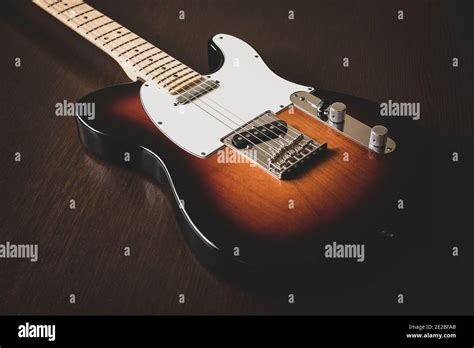 Fender American Telecaster in Vintage Sunburst on a wooden background Stock Photo - Alamy