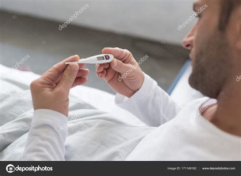 Sick Man looking at thermometer — Free Stock Photo © AllaSerebrina ...