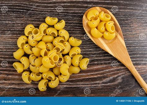 Heap Pasta Lumache, Pasta in Spoon on Wooden Table. Top View Stock Photo - Image of uncooked ...