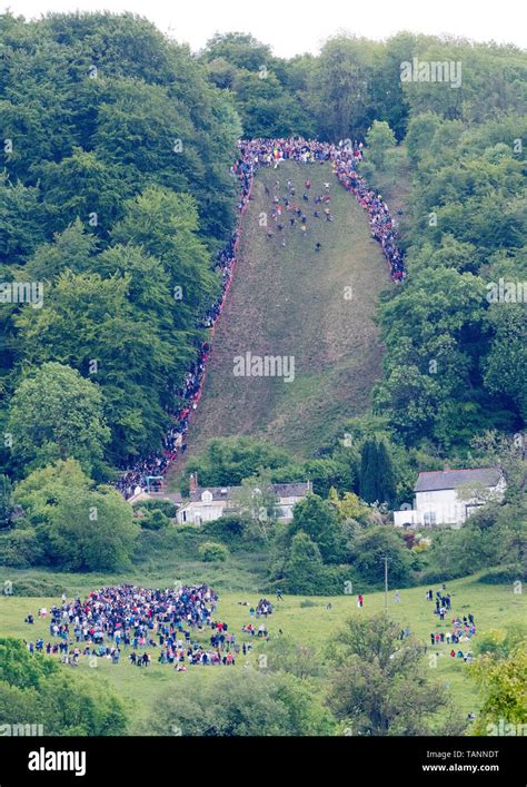 Participants take park in the annual cheese rolling races down Coopers Hill chasing a Double ...