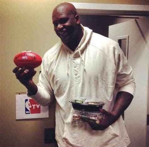 Shaq holding an AFL football and I’m pretty sure sure sushi : r/ShaqHoldingThings