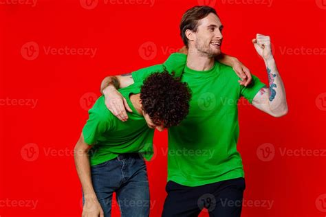 funny friends green t-shirts hugs emotions joy red background 22255034 Stock Photo at Vecteezy