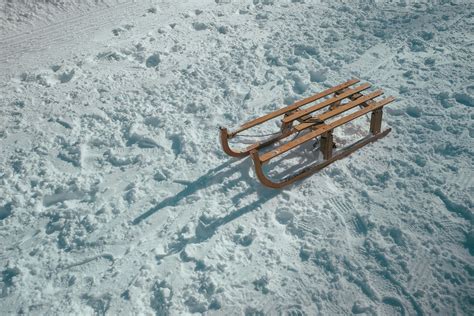 winter brown sled on snow during daytime sleigh Image - Free Stock Photo