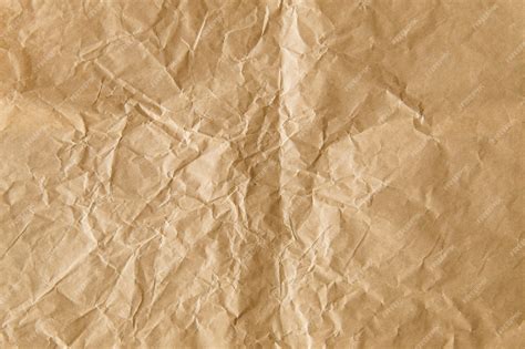 Premium Photo | Crumpled brown paper textured background