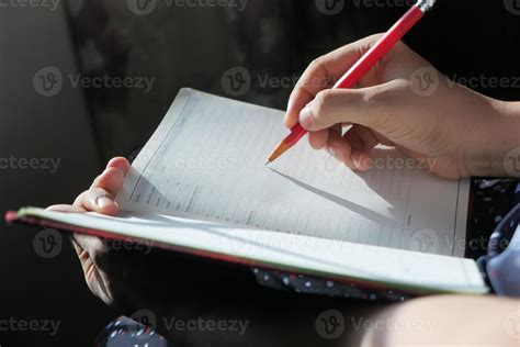 Person writing into a journal 2238626 Stock Photo at Vecteezy