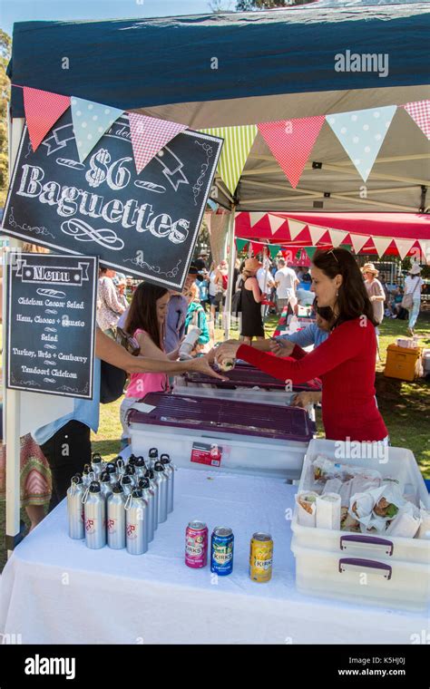 Parent selling French baguettes on a Sydney school fete stall to raise funds for the primary ...