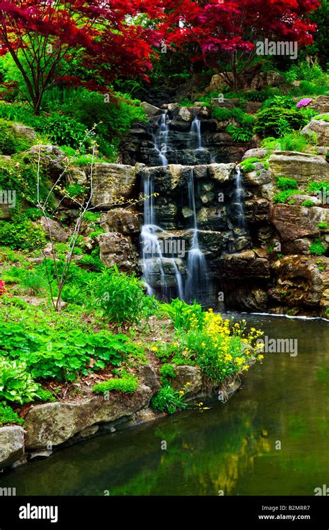 Cascading waterfall and pond in japanese garden Stock Photo - Alamy