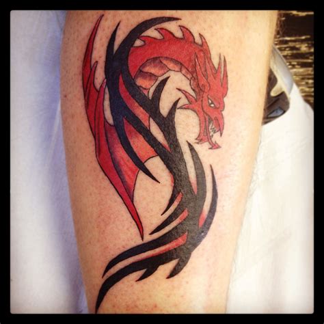 Dragon tattoo with tribal. I tweaked this design to make the dragon resemble a welsh dragon ...