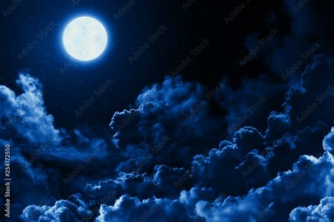 Mystical bright full moon in the midnight sky with stars surrounded by ...