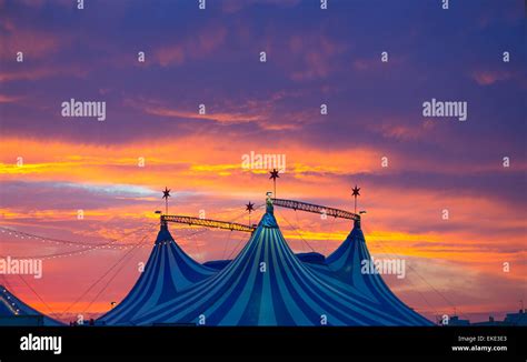 Circus tent in a dramatic sunset sky colorful Stock Photo - Alamy