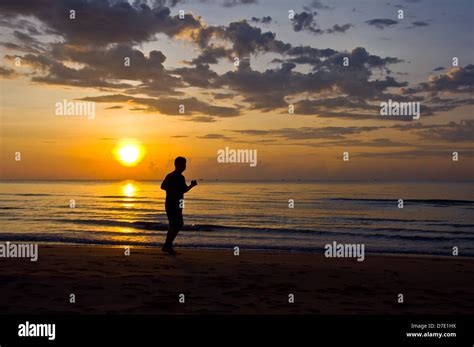 silhouette of man running on the beach Stock Photo - Alamy