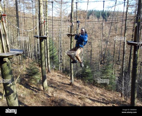 Teenage girl doing Go Ape in Dalby forest Stock Photo - Alamy