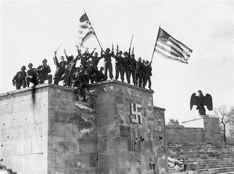 American soldiers from the 45th infantry division celebrate atop the Luitpold Arena in Nuremberg ...