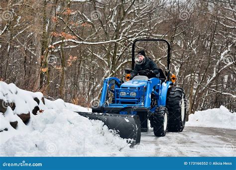 Plowing Snow in a Tractor stock photo. Image of frozen - 173166552