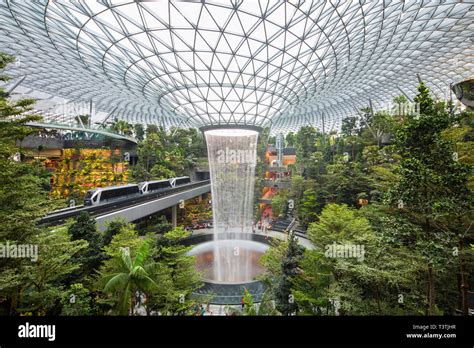 Lush view of Shiseido Forest Valley and the rain vortex at Jewel Changi Airport, Singapore Stock ...