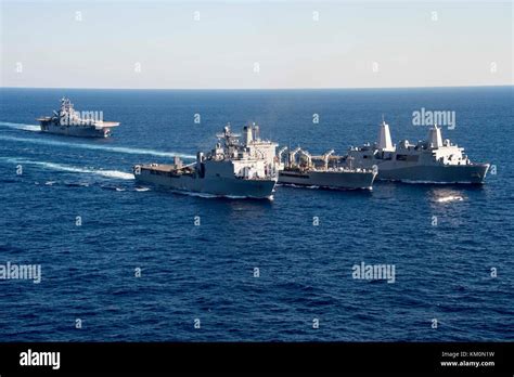 The U.S. Navy Harpers Ferry-class amphibious dock landing ship USS Oak Hill (left), U.S. Navy ...