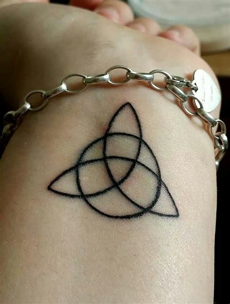 Triquetra tattoo on wrist | Ancient symbols tattoo, Finger tattoos, Small tattoos