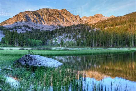 USA, California, Sierra Nevada Mountains. Calm reflections in Grass Lake. - Stock Photo - Dissolve