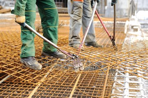 Premium Photo | A construction worker hooking up iron beams