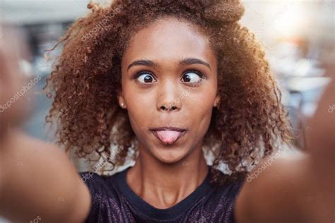 Woman making silly face while taking selfie Stock Photo by ©mavoimages ...