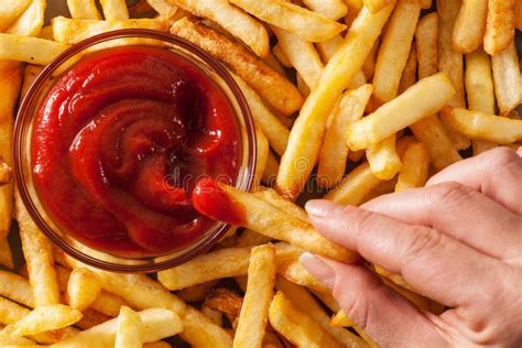 Hand Dipping French Fries in Tomato Sauce or Ketchup Stock Photo - Image of menu, portions ...