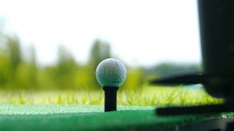 Close Up Ball on Tee Retired Golfer Taking Swing Hitting Golf Ball Off ...