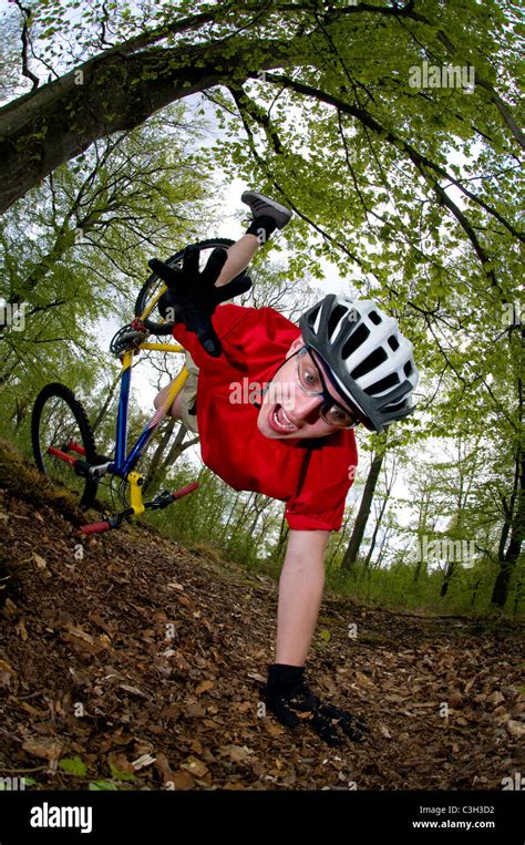 Young man falling off of bicycle dramatically Stock Photo - Alamy