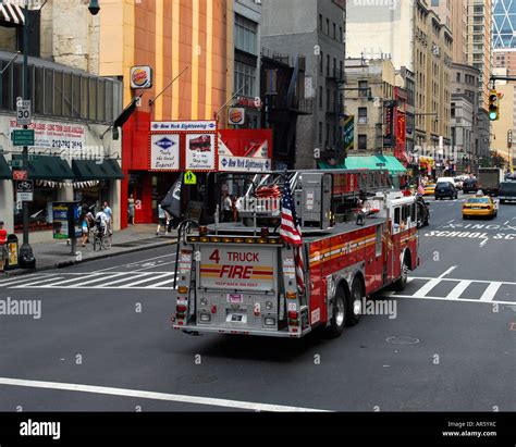 Ladder Truck 4 FDNY Fire department New York drives along eigth avenue Manhattan New York USA ...